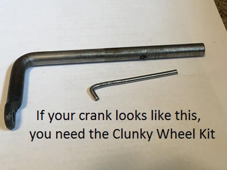 May include: A close-up of a metal crank arm and a small metal hook. The text "If your crank looks like this, you need the Clunky Wheel Kit" is visible below the image.