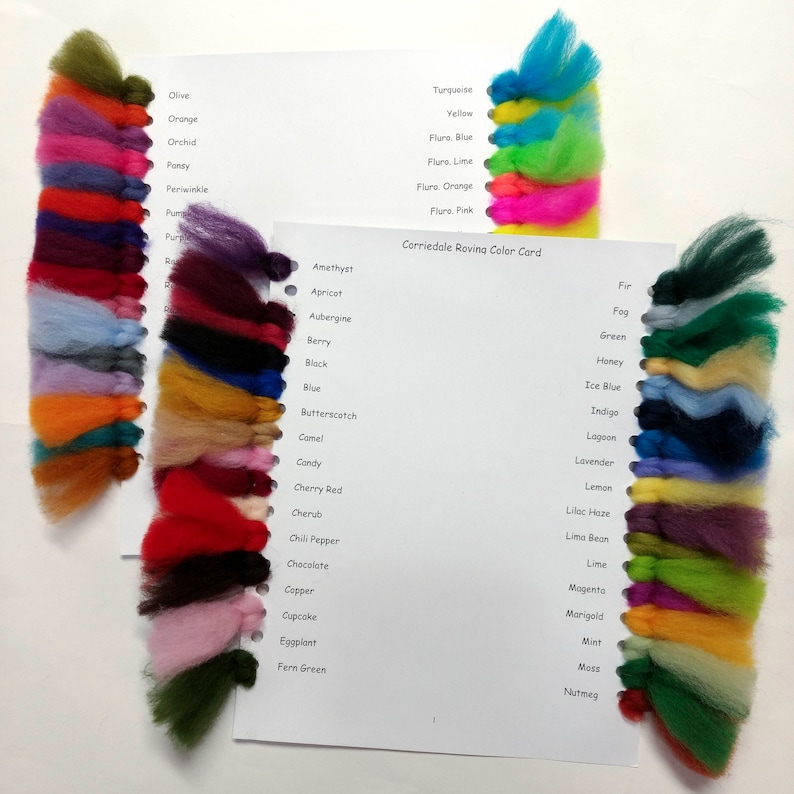 May include: A color card with wool samples in various colors, including turquoise, yellow, lime, orange, pink, amethyst, apricot, aubergine, berry, black, blue, butterscotch, camel, candy, cherry red, cherub, chili pepper, chocolate, copper, cupcake, eggplant, fern green, fir, fog, green, honey, ice blue, indigo, lagoon, lavender, lemon, lilac haze, lima bean, lime, magenta, marigold, mint, moss, and nutmeg. The card is titled "Corriedale Roving Color Card".