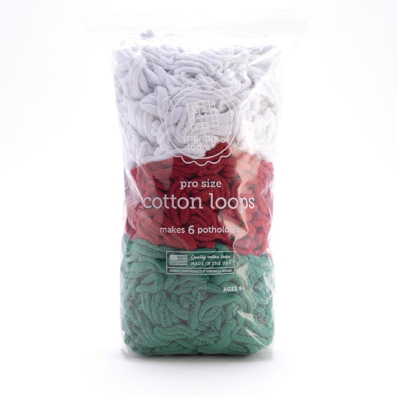 May include: A clear plastic bag filled with white, red, and green cotton loops. The bag has text that reads "pro size cotton loops" and "makes 6 potholders." The product is made in the USA and is for ages 8 and up.
