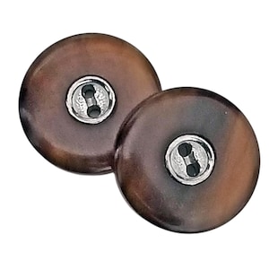 May include: Two brown and black buttons with a silver two-hole shank.