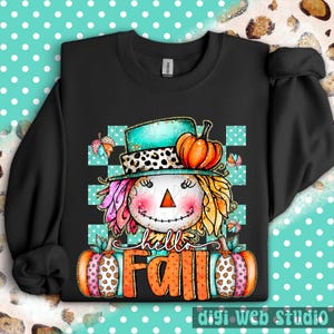 May include: Black sweatshirt featuring a colorful scarecrow design with a teal hat, orange pumpkin, and the words "hello FALL". The scarecrow has pink, yellow, and orange hair, and is set against a teal and white checkered background.