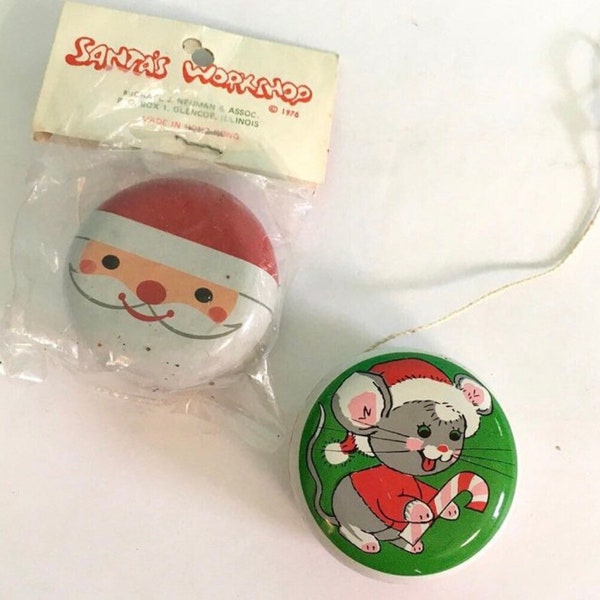 Set of 2 metal yo-yos, Christmas themed! 1 in original package, both good condition. Mouse marked Kurt S Adler. Santa dated 1976. 2 inch