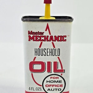 May include: A rectangular metal container of Master Mechanic household oil with a yellow spout and red cap. The white label features red and black text, including the volume 4 FL. OZS. and a danger warning about the contents being harmful or fatal.