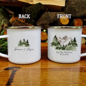 May include: White enamel mug with a silver rim, featuring a watercolour design of pine trees and mountains. The front of the mug reads "Big Sky, Montana 09.22.2026". The back of the mug has a watercolour design of pine trees and the names "Bianca & Ryan".