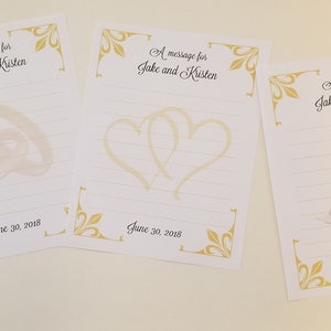 May include: Four white cards with gold borders and a gold floral design. Each card has a different illustration: a ring, two rings, two hearts, and two champagne glasses. Each card has the text "A message for Jake and Kristen" and "June 30, 2018".