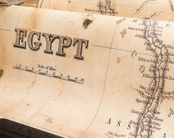 Egypt map showing river Nile from Asuan to Mediterranean, including Cairo, Suez, ancient scrolls made of massive wood.