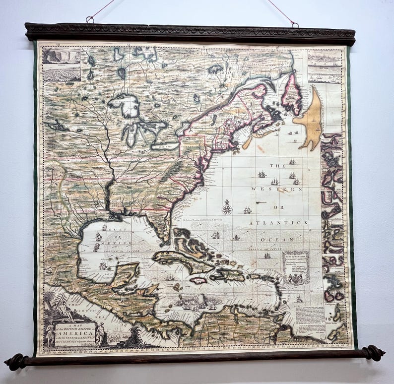 Puede incluir: Un mapa antiguo de Am&eacute;rica del Norte, impreso en papel y montado en un rodillo de madera. El mapa muestra la costa este de Am&eacute;rica del Norte, incluidas las islas del Caribe. El mapa est&aacute; titulado "A Map of the British Empire in America, as it existed in the year 1763."