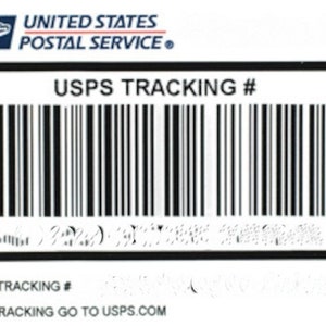 May include: A white USPS shipping label with the text "UNITED STATES POSTAL SERVICE" and "USPS TRACKING #". The label includes a barcode and the text "FOR TRACKING GO TO USPS.COM". The date "Oct. 2015" is also visible.