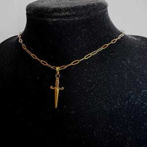 Dagger/sword charm on paperclip gold toned chain