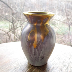 May include: A set of three ceramic nesting bowls in shades of blue, green, and white. The bowls feature a speckled glaze and a simple, modern design. The largest bowl measures approximately 6 inches in diameter.