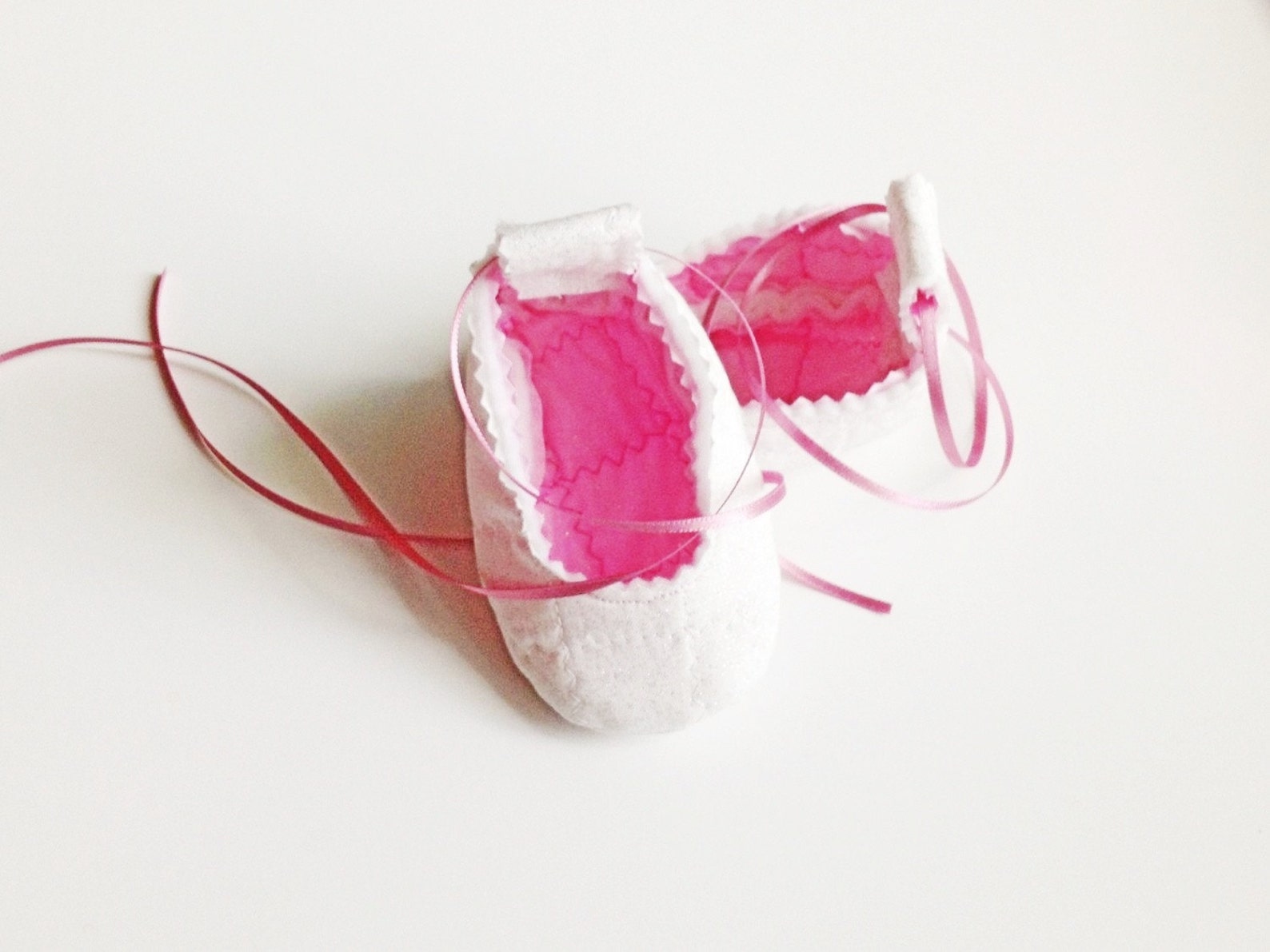 white sparkly baby ballerina slippers with pink sparkly lining, tie up the legs like real ballet flats, great baby gift!