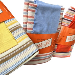 May include: Three packages of striped fabric labeled "Ready-to-Sew Tee-Jet". The fabric is in various colors, including yellow, orange, blue, and brown.