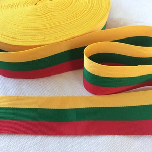 May include: Yellow, green and red striped ribbon, resembling the Lithuanian flag.