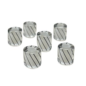 May include: Six clear glass beads with a cylindrical shape. Each bead has a white interior and is decorated with black diagonal stripes. The beads are arranged on a white background.