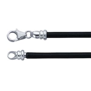 May include: A black cord necklace with a silver-colored clasp and end piece. The clasp is a lobster claw style, and the end piece has a loop. The cord is a solid black color.