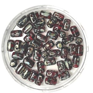 May include: A selection of dark red, black, and white glass beads in a clear plastic container. The beads are a mix of rectangular and round shapes, with a speckled design. These beads are suitable for jewellery making or other craft projects.