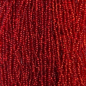 May include: Close-up of a vibrant red beaded curtain. The beads are small, rectangular, and strung closely together, creating a shimmering, textured surface. The color is a deep, rich red, with a slight metallic sheen.