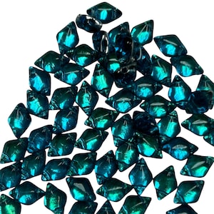 May include: A collection of iridescent, diamond-shaped glass beads in shades of teal and deep blue. The beads have a reflective, glossy finish, creating a shimmering effect. Ideal for jewelry making or craft projects.