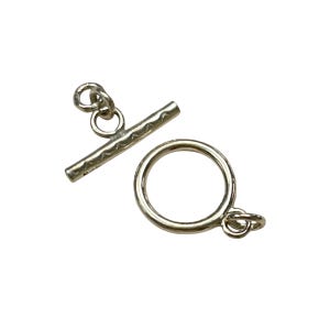 May include: Silver toggle clasp with a textured bar and a round ring. The clasp is used for necklaces, bracelets, and other jewellery.