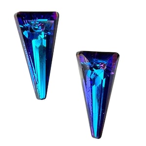 May include: A pair of iridescent blue and purple triangle shaped earrings. The earrings are pointed at the bottom and have a faceted design.