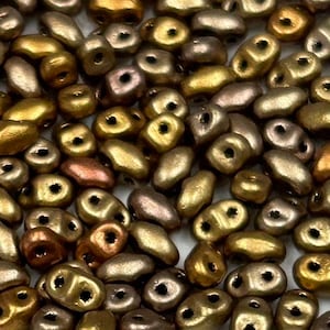May include: A collection of small, irregular shaped glass beads in shades of gold, bronze, and copper. The beads have a metallic sheen and are perfect for jewelry making.