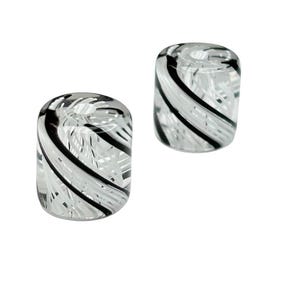 May include: Two clear glass beads with a black and white swirl pattern.