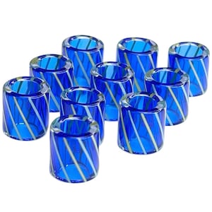 May include: Ten blue glass candle holders with white stripes. The candle holders are cylindrical in shape and have a smooth, polished finish.
