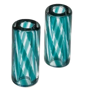 May include: Two teal blue glass candle holders with a white swirl pattern. The candle holders are cylindrical in shape and have a smooth, polished finish.