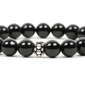 May include: A black onyx beaded bracelet with a silver bead accent.
