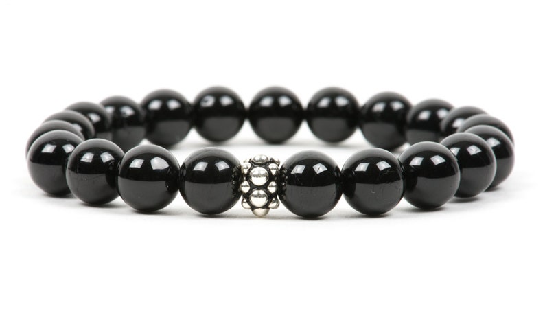 May include: A black onyx beaded bracelet with a silver bead accent.