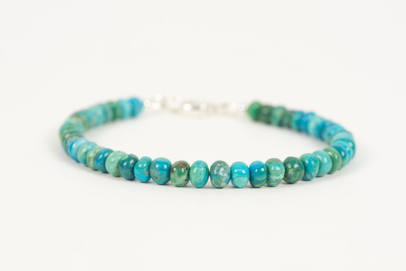 May include: A turquoise and green gemstone bracelet with a silver clasp.