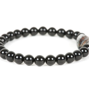 May include: A black beaded bracelet with a silver and brown bead accent.