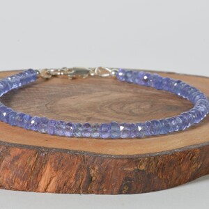 May include: A delicate bracelet made with light blue faceted gemstone beads. The bracelet has a silver clasp.