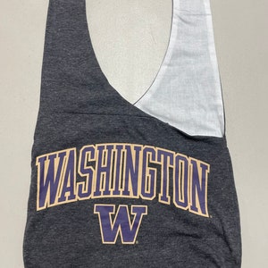 May include: A gray and white tote bag with the text "WASHINGTON" in gold letters and a purple "W" logo.