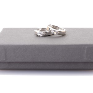 Sterling silver huggie earrings with a cz stone
