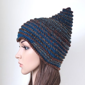 May include: A blue and brown striped knitted hat with a pointed top. The hat is made from a soft, warm yarn and is ideal for keeping your head warm in the winter.