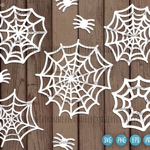 May include: A set of ten white, intricate, spiderweb-shaped cutouts. The cutouts are designed for crafting and can be used for scrapbooking, card making, or other DIY projects.
