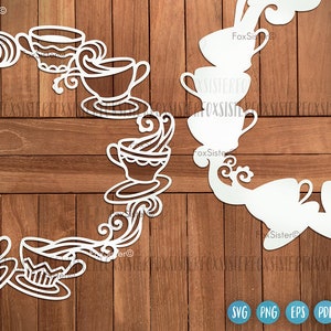 May include: White silhouette of a teacup and teapot wreath with floral details. The wreath is on a wood background.
