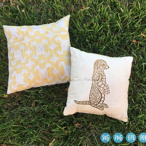 May include: Two white pillow covers with brown embroidery. One pillow has a geometric pattern and the other has a detailed outline of a meerkat.