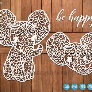 May include: Two white elephant silhouette cutouts with intricate mandala designs. The text "be happy" is above the elephants.