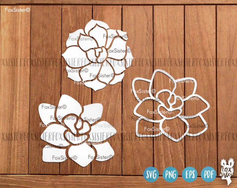 May include: Three white cutout designs of succulent plants on a wood background. The designs are for crafting and can be used for making cards, home decor, or other projects.