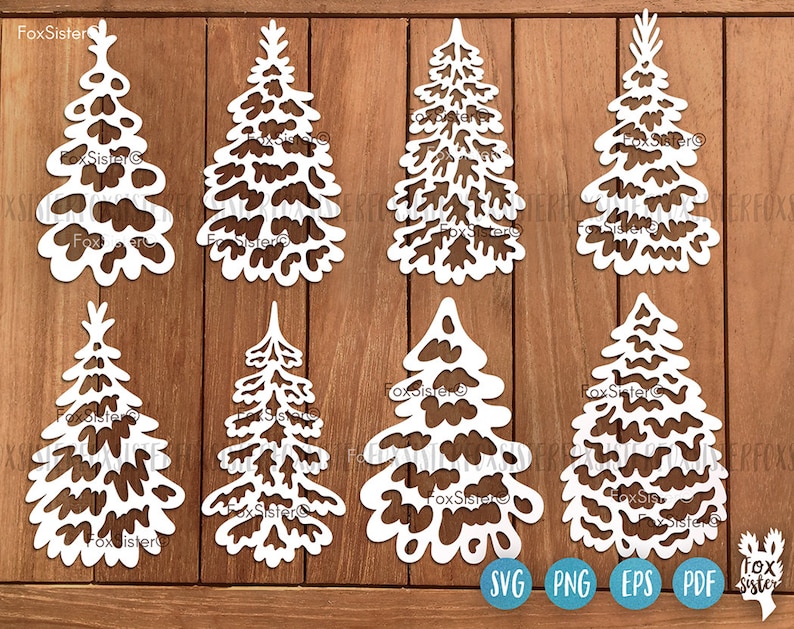 May include: Set of eight white, intricately cut paper Christmas tree designs. The trees are all different shapes and sizes, with a variety of cutouts and patterns. The designs are perfect for crafting, scrapbooking, or decorating.