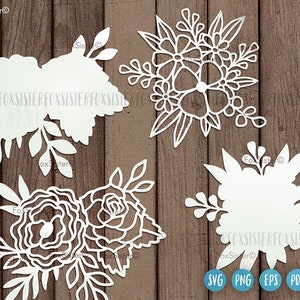 Op de afbeelding: Vier witte bloemmotieven met ingewikkelde details, perfect voor knutselen of scrapbooking. De motieven bevatten verschillende bloemvormen en bladeren, wat een delicate en elegante uitstraling cre&euml;ert.
