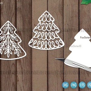 May include: Three white paper cut-out Christmas tree designs. The first tree has a simple, elegant design with a single trunk and branches. The second tree has a more intricate design with a series of loops and swirls. The third tree is a simple outline of a Christmas tree.
