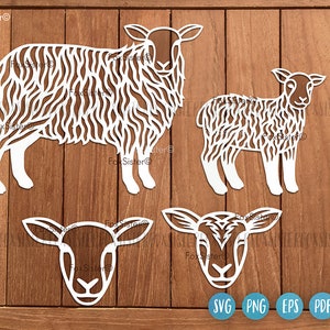 May include: Three white paper cut-out sheep designs. The largest sheep is standing with its head turned to the left. The medium-sized sheep is standing with its head turned to the right. The smallest sheep is only a head and neck, facing forward. The designs are on a woodgrain background.