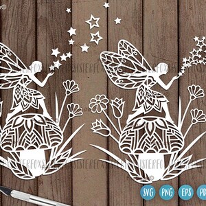 May include: Two white paper cut-out fairies blowing on stars. Each fairy is sitting on a flower with intricate mandala designs. The fairies are surrounded by flowers and stars.