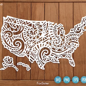 May include: A white outline of the United States of America with a decorative, intricate pattern inside the borders. The outline includes Alaska and Hawaii.