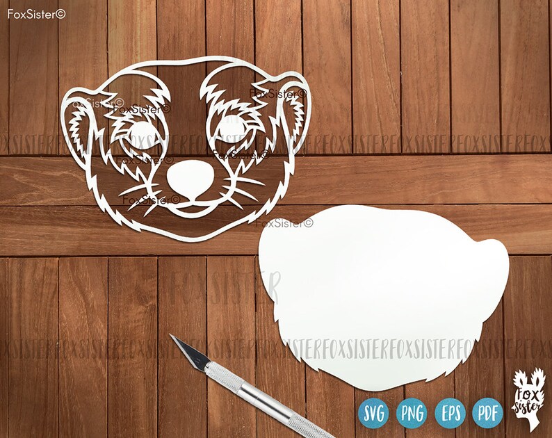 May include: A white cutout of a meerkat face with a blank white cutout of a meerkat body. The cutouts are on a wood background.
