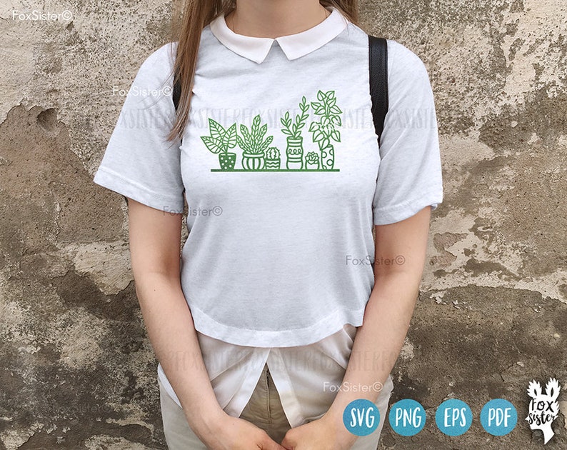 May include: White t-shirt with a graphic of potted plants in green and black outlines. The plants are in different shapes and sizes, and the pots are all different colors.