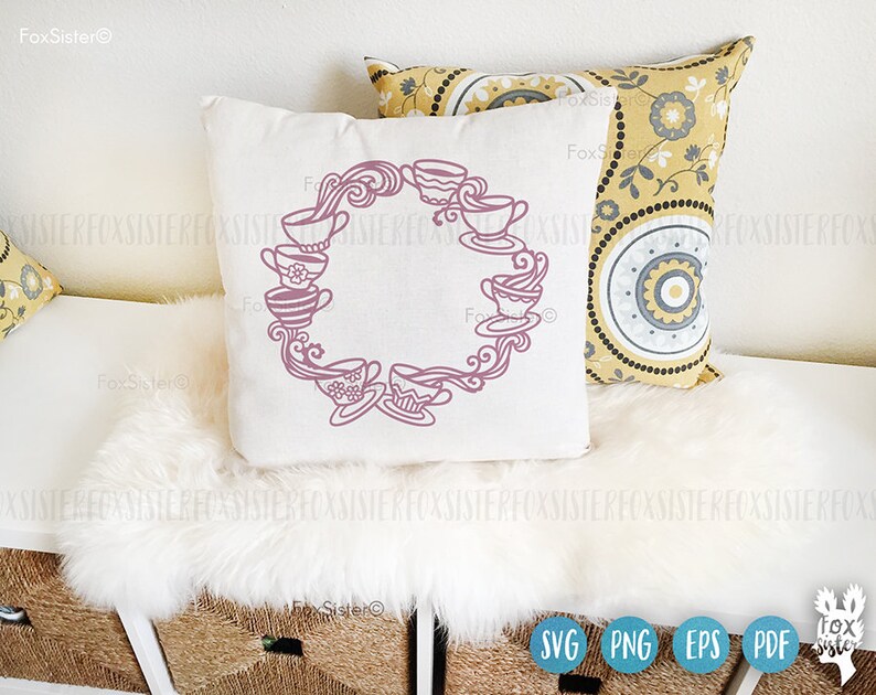 May include: A white pillow with a pink design of teacups in a circle. The teacups are arranged in a circle with a swirl design in the center. The pillow is on a white fluffy surface.